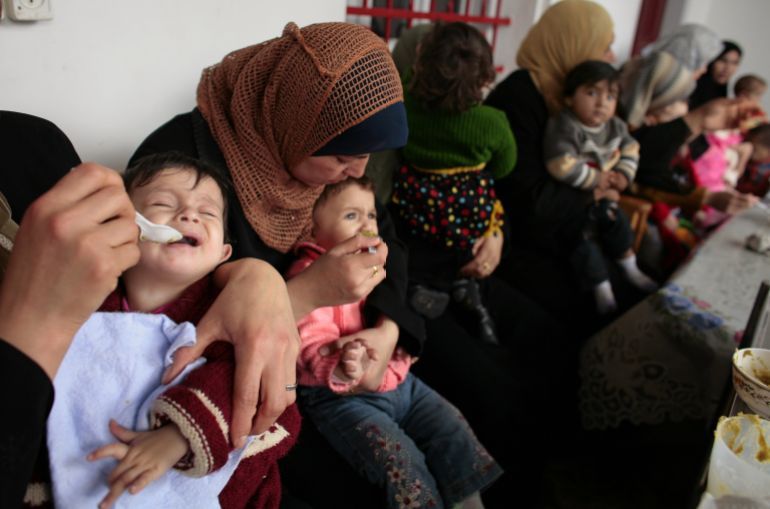 GAZA CITY, GAZA STRIP - APRIL 6: Palestinian mothers feed their babies during a feeding program at the Ard El Insan-Terres de Homme clinic on April 6, 2006 in Gaza City, Gaza Strip. The specilaized clinic deals with infants suffering from anemia and malnutrition due to lack of iron, vitamin D and calcium. A shortage of infant formula and the constant border closings make some food products for babies hard to come by along with the financial burdens that large Gaza families deal with daily. (Photo by Paula Bronstein/Getty Images)