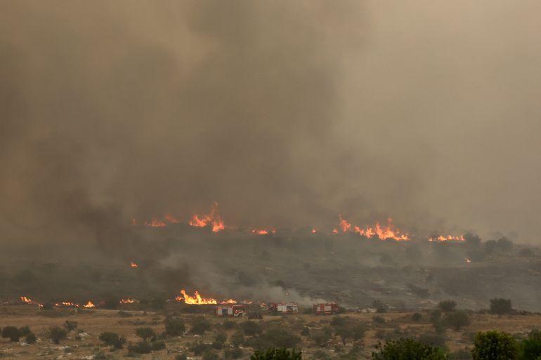 Flames engulf vegetation during a forest fire near the central Israeli town of Bet Shemesh on April 30, 2025. (Photo by Ahmad GHARABLI / AFP)