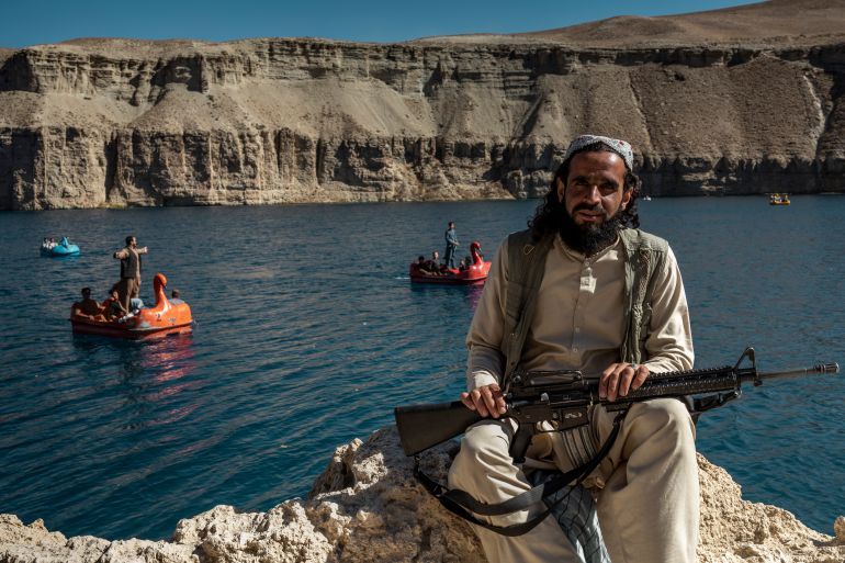 BAND E AMIR, AFGHANISTAN - OCTOBER 6: A Taliban member enjoys one of the six lakes of Band-e Amir National Park on October 6, 2021 in Band-e Amir, Afghanistan. Since the Taliban retook control of Afghanistan in August 2021, the economy has suffered after the world aid funding stopped, which has created a humanitarian crisis. Most art, culture and pastimes have been banned. The female population have also had to quit jobs and young girls after the age of 12 can no longer go to school or further education. (Photo by Marco Di Lauro/Getty Images)