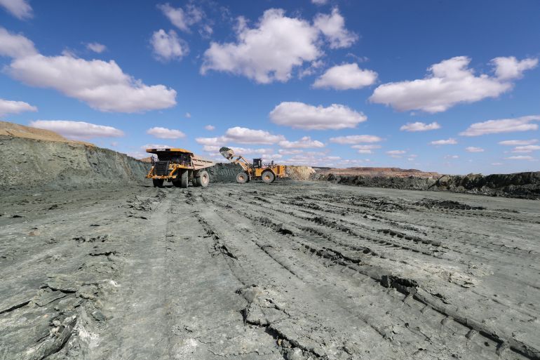A bulldozer loads ore into a dump truck during operations at Varvarinskoye gold deposit in the Kostanay region, Kazakhstan, April 15, 2025. REUTERS/Pavel Mikheyev