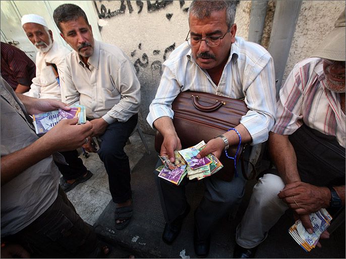 epa01852340 Palestinian money-changers seen at the currency market area of Gaza City, Gaza Strip on 08 September 2009. There is no official currency in the Palestinian Territories as Israel refused to allow Palestinians to have their own currency when an economic agreement was signed between Israel and the Palestine Liberation Organization (PLO) in 1994. The Israeli shekel, which is most commonly used, has almost disappeared since Hamas took control of the Gaza Strip in 2007. EPA/ALI ALI