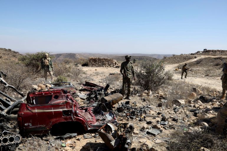 Puntland security forces stand guard near the wreckage of a vehicle after capturing an ISIS base in Cal Miskaad mountain range in Bari, east of the Gulf of Aden in the city of Bosasso, Puntland region, Somalia January 25, 2025 REUTERS/Feisal Omar