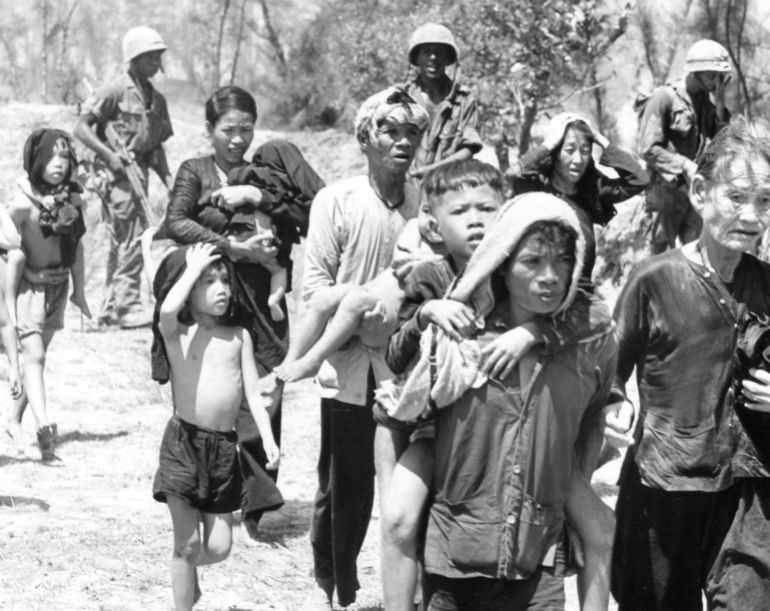 Villagers evacuate An Hoa as a battle raged between the Viet Cong and U.S. Marines who had made an amphibious landing on the island, July 9, 1965. The Marines defeated the Communist forces that had previously engaged South Vietnamese troops there. (AP Photo)