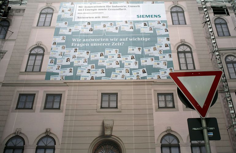 MUNICH, GERMANY - MAY 26: The headquarter of Siemens AG , Europe's biggest engineering company is covered with a mock facade scaffolding during renovation work on May 26, 2008 in Munich, Germany. A trial against Reinhard Siekaczek, former Siemens manager, startet at Munich court in the morning. In a case that may reveal the scale of a suspected bribery network already put at more than 1 billion euros ($1.6 billion), by German engineering giant Siemens, Siekaczek is accused of building a system of slush funds and front firms to hide illegal money transfers. (Photo by Johannes Simon/Getty Images)