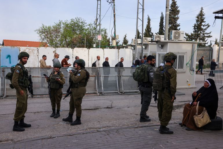 Palestinian Muslims wait at an Israeli checkpoint in Bethlehem, in the occupied West Bank, on March 14, 2025, to go to the Al-Aqsa Mosque compound in east Jerusalem for Friday prayers during the holy fasting month of Ramadan. (Photo by Hazem BADER / AFP)