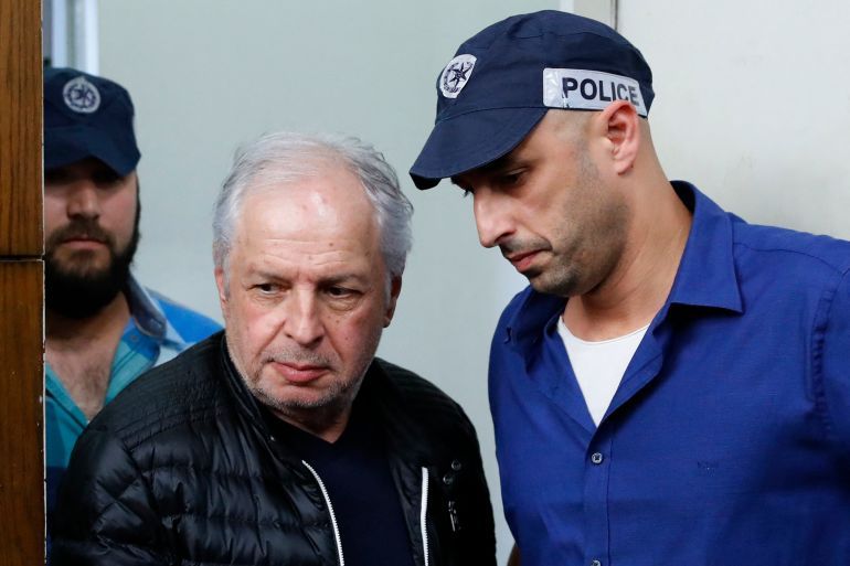 Israeli tycoon Shaul Elovitch (C) appears in the Justice Court in Tel Aviv in one of the graft probes threatening Israel's prime minister on February 22, 2018. Shaul Elovitch, the controlling shareholder of Israeli telecommunications giant Bezeq, is accused of having given Israeli Premier Benjamin Netanyahu positive coverage on his Walla! news site in exchange for policies benefiting the business. (Photo by JACK GUEZ / AFP)