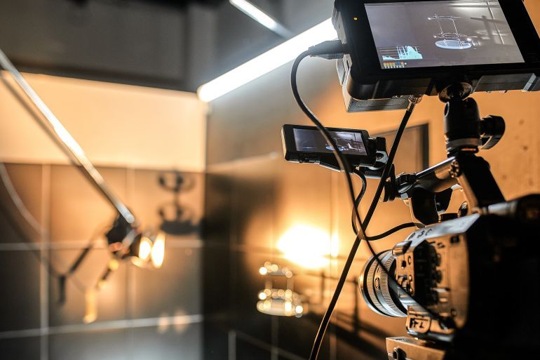 Behind the scenes of filming movies and video products, setting up equipment for shooting video and sound. The concept of producing video content for social networks, TV and blogs ادوبي ستوك