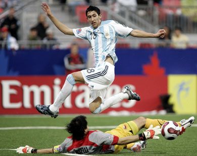 Argentina's Angel Di Maria leaps over Chilean goal keep Cristopher Toselli during their semi-final match at the FIFA U-20 World Cup 19 July 2007 in Toronto, Ontario, Canada.