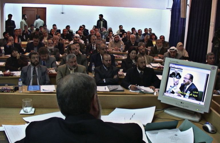 GAZA CITY, GAZA STRIP -MARCH 06: Palestinian members of the Palestinian Legislative Council attend the first session as newly elected lawmakers, at the PLC building in Gaza City, Gaza Strip, March 6, 2006. The new Palestinian parliament began its first working session today since the Islamic Resistance Movement, Hamas, won a landslide election victory in January. The new speaker of the legislative council, Hamas deputy Aziz Dweik, opened proceedings in front of 112 of the 132 MPs many of whom took part via video-link from the parliament's regional base in Gaza City because of Israeli-imposed travel restrictions. (Photo by Palestinian Parliament via Getty Images)