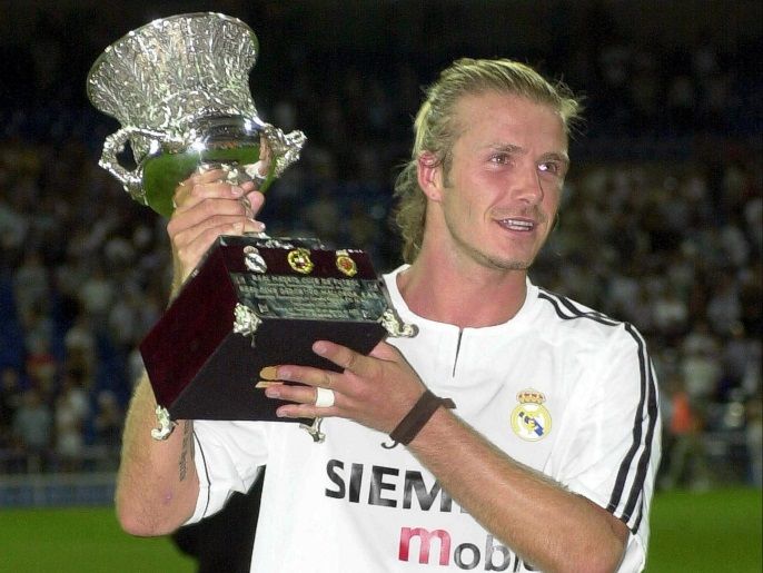 (FILE) A file picture dated 27 August 2003 shows Real Madrid's English midfielder David Beckham celebrating with the trophy after his team defeated Real Mallorca in the Spanish Super Cup second leg soccer match at Santiago Bernabeu stadium in Madrid, Spain. Former England captain David Beckham is to announce his retirement from professional soccer at the end of the season, the 38-year-old midfielder of Paris Saint Germain confirmed on 16 May 2013.