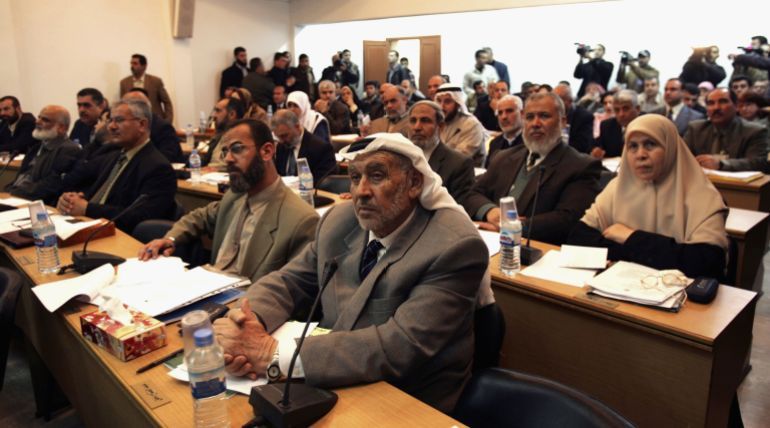 GAZA CITY, GAZA STRIP -MARCH 06: Palestinian members of the Palestinian Legislative Council attend the first session as newly elected lawmakers, at the PLC building in Gaza City, Gaza Strip, March 6, 2006. The new Palestinian parliament began its first working session today since the Islamic Resistance Movement, Hamas, won a landslide election victory in January. The new speaker of the legislative council, Hamas deputy Aziz Dweik, opened proceedings in front of 112 of the 132 MPs many of whom took part via video-link from the parliament's regional base in Gaza City because of Israeli-imposed travel restrictions. (Photo by Abid Katib/Getty Images)