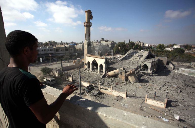 GAZA CITY, GAZA - AUGUST 25: A Palestinian man looks at the rubble of Omar Ibn Abd al-Aziz mosque destroyed in an Israeli air strike in the northern Gaza Strip town of Beit Hanoun on August 25, 2014. At least 2126 Palestinians have been killed, more than 10,860 others injured and 100 mosques have been damaged in relentless Israeli attacks on the Gaza Strip since hostilities began on July 7. (Photo by Ashraf Amra/Anadolu Agency/Getty Images)