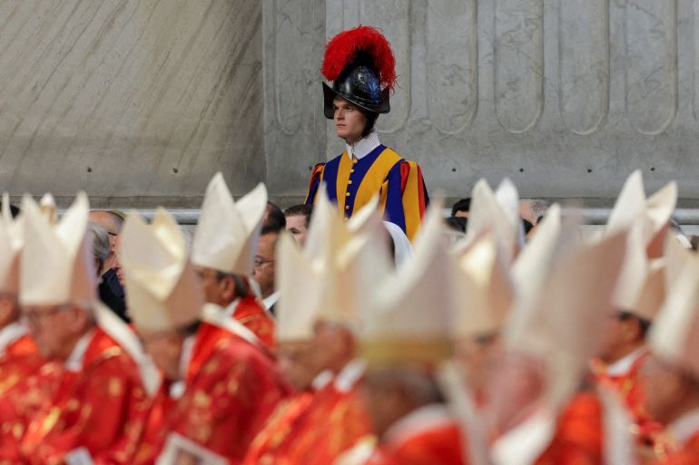 A Swiss Guard stands, as Dean of the College of Cardinals, Cardinal Giovanni Battista Re, presides over the Holy Mass, celebrated for the election of the new pope, in St. Peter’s Basilica, at the Vatican, May 7, 2025. REUTERS/Murad Sezer TPX IMAGES OF THE DAY