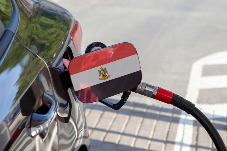 Flag of Egypte on the car's fuel tank filler flap. Fueling car with petrol pump at a gas station. Petrol station. Gasoline and oil products. Close up.; Shutterstock ID 1154884765; purchase_order: aj; job: ; client: ; other: