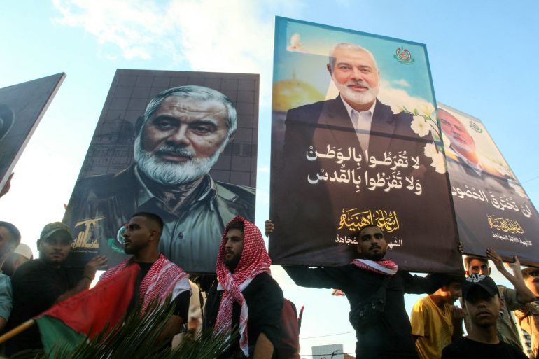 People take part in a march called by Palestinian and Lebanese youth organisations in the southern Lebanese city of Saida, on August 5, 2024, to protest against the assassination of Hamas chief Ismail Haniyeh (portrait) and a Hezbollah military commander. - Haniyeh and a bodyguard were killed in a pre-dawn