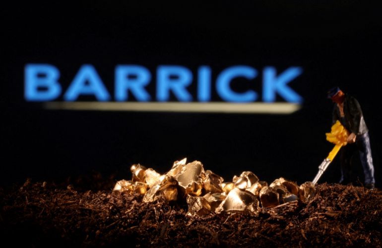 FILE PHOTO: A small toy figure and gold imitation are seen in front of the Barrick logo in this illustration taken November 19, 2021. REUTERS/Dado Ruvic/Illustration//File Photo
