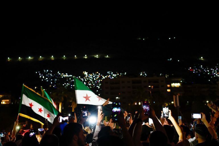 People celebrate after U.S. President Donald Trump said on Tuesday he would order the lifting of sanctions on Syria, in Damascus, Syria May 13 , 2025. REUTERS/Yamam Al Shaar