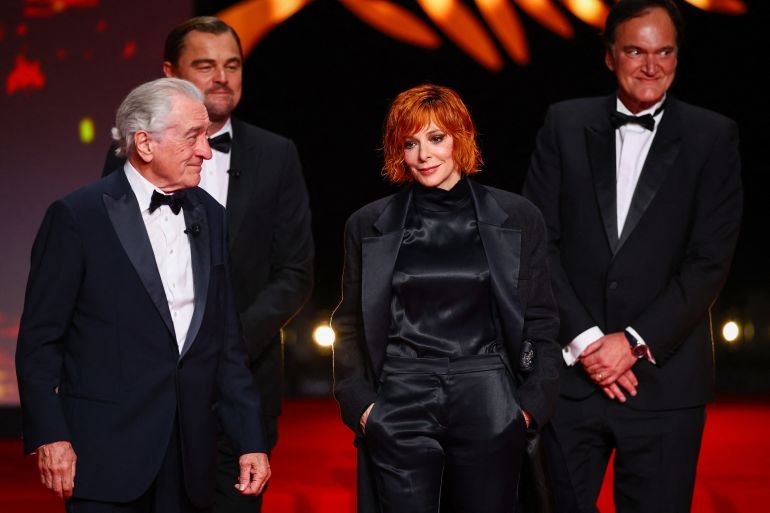 Leonardo DiCaprio, Quentin Tarantino, Robert De Niro and Mylene Farmer, pose on stage at the end of the opening ceremony, before the screening the film