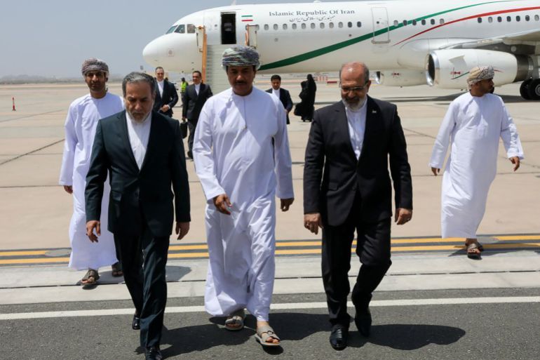 This handout picture provided by the Iranian Foreign Ministry on May 11, 2025, shows Iran's Foreign Minister Abbas Araghchi (L) arriving in Muscat.