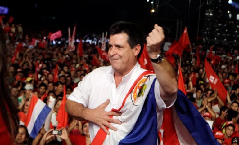 In this April 5, 2013 file photo, Horacio Cartes, presidential candidate of the Colorado Party, dances during a campaign rally in Capiata, Paraguay, the year after Paraguay’s Senate removed then-President Fernando Lugo from office in a rapid impeachment trial [File: Jorge Saenz/AP]