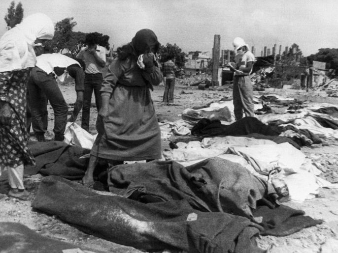 Palestinian, holding handkerchiefs to their faces, look for the bodies of relatives, victims of the massacres in the Palestinian refugee camp of Sabra, in West Beirut 21 September 1982. Hundreds of Palestinian refugees were massacred 17 September 1982 in Sabra and Chatila, the two biggest camps in Lebanon, when right wing forces entered the camp.