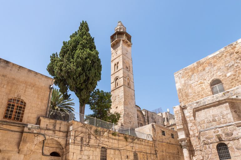 Jerusalem, Israel, June 13, 2020 : Minaret of the Omar Mosque located opposite the entrance to the Church of the Holy Sepulchre in the old city of Jerusalem, Israel; Shutterstock ID 1759121915; purchase_order: aj; job: ; client: ; other: