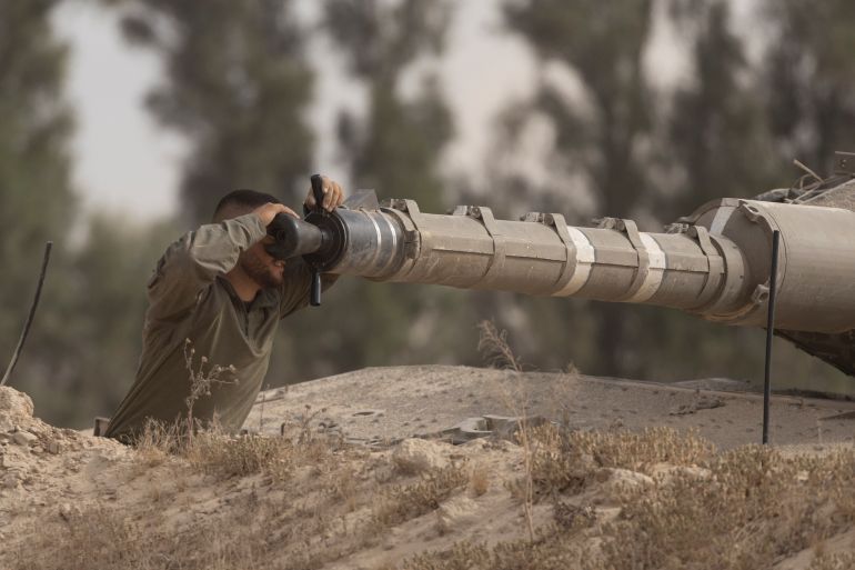 SOUTHERN ISRAEL, ISRAEL - MAY 19: An Israeli soldier works on a tank cannon near the border with the Gaza Strip on May 19, 2025 in Southern Israel, Israel. The Israeli military has said its expanding ground operations in Gaza as part of what they're calling 'Operation Gideon's Chariots,' aimed at securing the release of hostages still held in Gaza, as well as