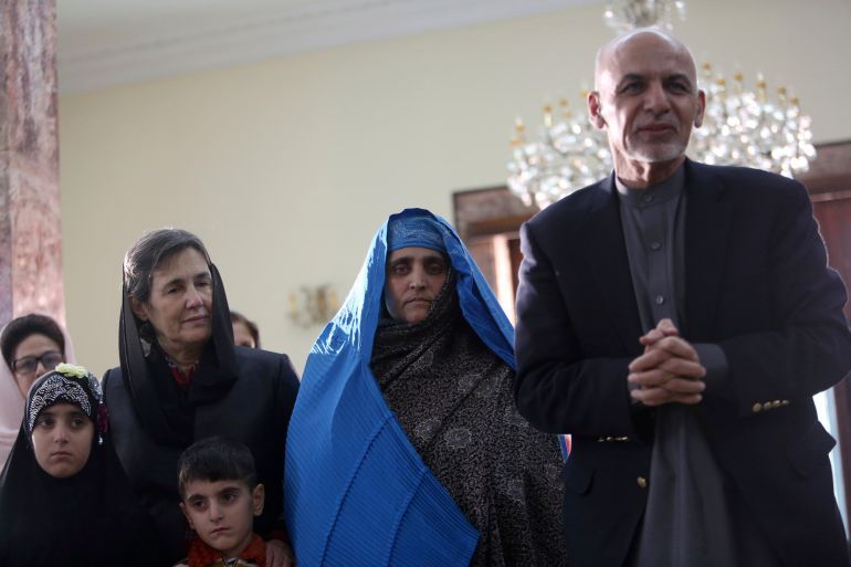 Afghan President Ashraf Ghani, right, meets with National Geographic's famed green-eyed