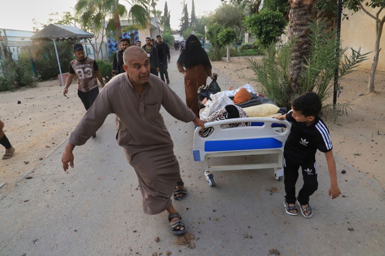 Palestinians evacuate patients from the European hospital in Khan Younis, Gaza, after it was hit by an Israeli army airstrike, Tuesday, May 13, 2025. The Israeli military said it had carried out a strike targeting what it said was a Hamas