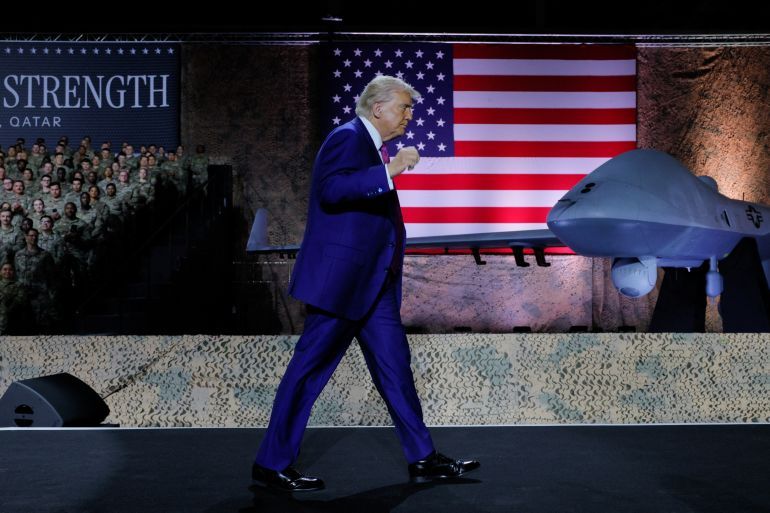 U.S. President Donald Trump walks near a drone and a U.S. flag, for an address to troops, during a visit to Al Udeid Air Base in Doha, Qatar, May 15, 2025. REUTERS/Brian Snyder