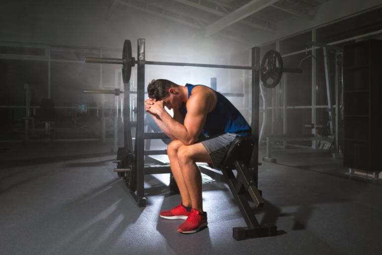 The depressed sportsman sit in the sport center
