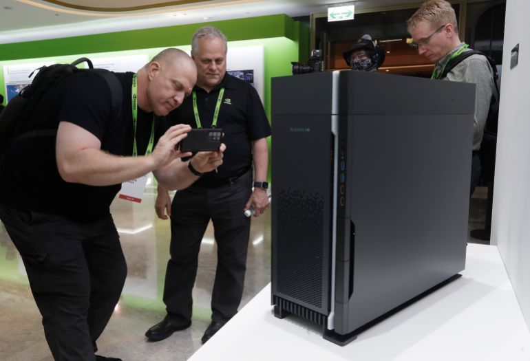 People take a photo of Nvidia Supermicro ARS-55NW (inside the case) during the Computex 2025 exhibition in Taipei, Taiwan, Wednesday, May 21, 2025. (AP Photo/Chiang Ying-ying)