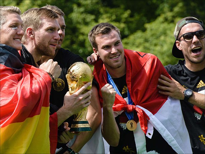 Players of the German national football team (L-R) Bastian Schweinsteiger, Per Mertesacker, Manuel Neuer, Kevin Grosskreutz and Lukas Podolski celebrate on a stage at the