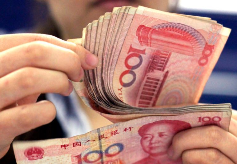 In this photo taken on Aug. 25, 2010, a bank clerk counts Chinese 100 Yuan notes in Shanghai. China’s politically sensitive yuan has sunk to a 22-month low against the dollar after the U.S. Treasury declined to label Beijing a currency manipulator amid a mounting tariff battle. (AP Photo/Eugene Hoshiko)