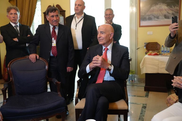 US special envoy for Syria, the ambassador to Turkey Thomas Barrack (seated) attends a flag-raising ceremony at the US ambassador's residence in Damascus on May 29, 2025.
