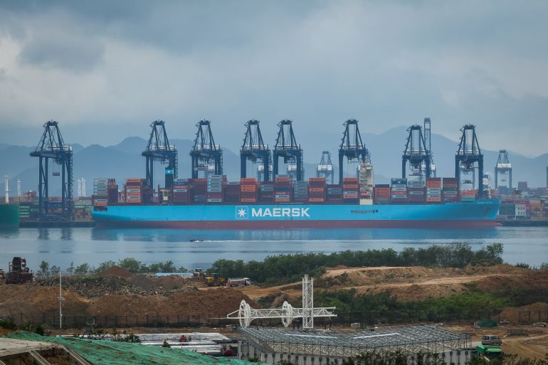 SHENZHEN, CHINA - APRIL 12: A large container vessel operated by Danish shipping giant Maersk is docked at the Yantian International Container Terminal, with gantry cranes unloading containers amid port expansion construction in the foreground, on April 12, 2025 in Shenzhen, China. China has imposed a new round of retaliatory tariffs on U.S. imports, raising duties to 125% in response to the latest escalation by the United States, which increased tariffs on Chinese goods to 145%. The growing trade tensions have further impacted China's export sector, affecting key industries such as logistics, manufacturing, and cross-border e-commerce. The measures are part of Beijing's broader strategy to counter rising economic pressure and defend its trade interests. (Photo by Cheng Xin/Getty Images)
