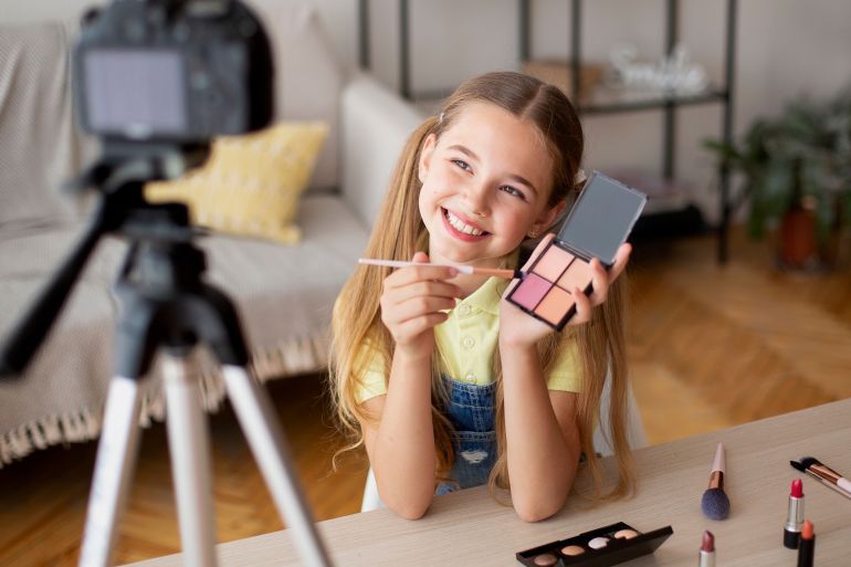 Beauty Blog. Young teenage girl recording vlog about cosmetics and makeup, showing her palette to camera