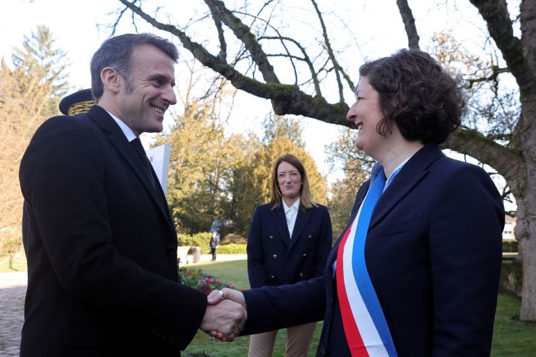 French President Emmanuel Macron shakes hands with Strasbourg's Mayor Jeanne Barseghian as they participate in a ceremony marking the 21st European Remembrance Day for Victims of Terrorism in Strasbourg, France, 11 March 2025. TERESA SUAREZ/Pool via REUTERS