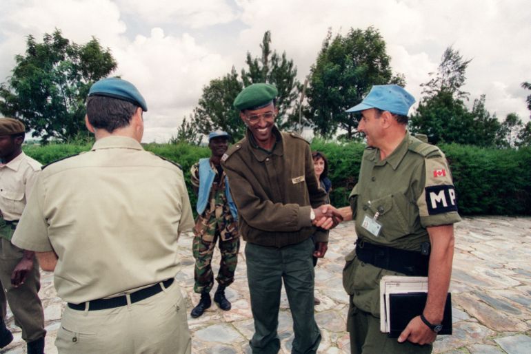 A picture taken 11 May 1994 in Buymba of Paul Kagame, leader of the Tutsi-led RPF (Rwandan Patriotic Front) shaking hands with an unidentified Canadian UN officer. After a week that saw strained ties between Rwanda and France snap over an indictment call on President Paul Kagame over alleged complicity in the death of his predecessor, local media rallied in support of the government and poured scorn on Paris. French Foreign Minister Philippe Douste-Blazy 26 November 2006 said he regretted Rwanda's decision to cut diplomatic ties, forcing French envoys and educational staff to repatriate in haste. AFP PHOTO / FILES GERARD JULIEN (Photo by GERARD JULIEN / AFP)