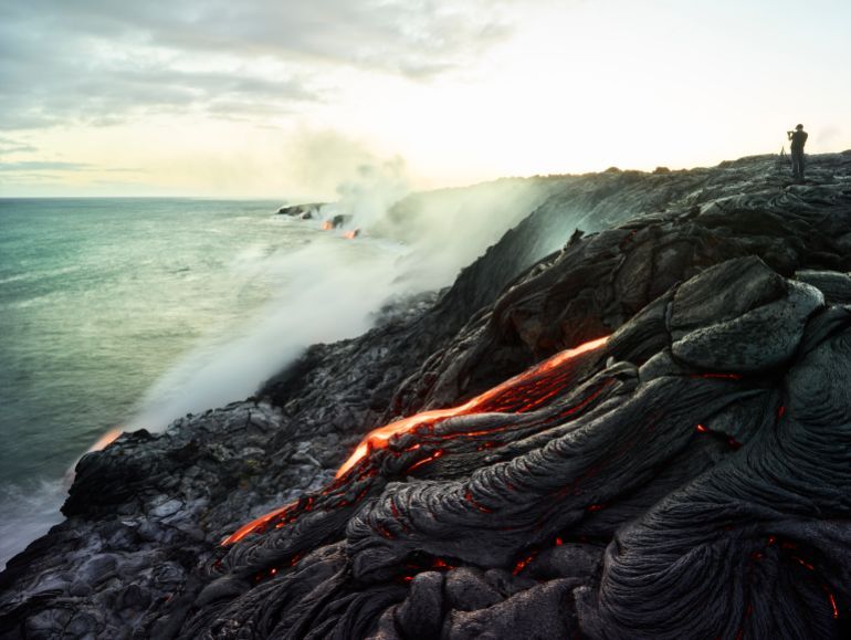 30-40 years; adults; big island; catastrophe; caucasian; cloud; colour; dramatic; experience; experiencing; hawaii; heat; lava field; man; mid adults; ocean; smoke; traveller; unusual; view; volcanism; volcanoes national park