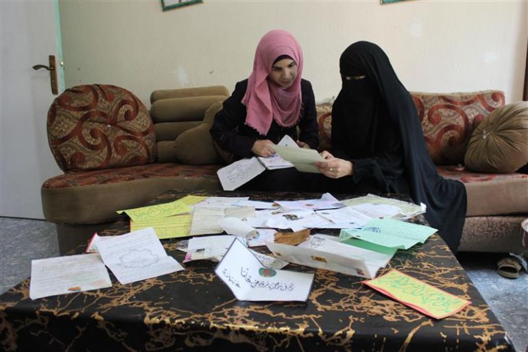 _2-أسيل جندي، السواحرة الشرقية، سامية على يسار الصورة وزينة ابنتها على يمينها تقلبان الرسائل التي وصلتهما من فهمي خلال سنوات اعتقاله (أرشيف الجزيرة نت 2021)