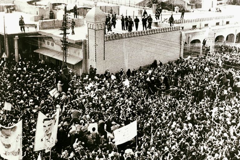 War and Conflict, Iraq, pic: 16th March 1959, Baghdad, Iraqi Premier General Abdel Kerim Kassem stands on the roof of the Ministry of Defence and waves to the throng below him, Thousands of pro - Kassem demonstrators paraded condemning the Mosul mutiny War and Conflict, Iraq, pic: 16th March 1959, Baghdad, Iraqi Premier General Abdel Kerim Kassem stands on the roof of the Ministry of Defence and waves to the throng below him, Thousands of pro - Kassem demonstrators paraded condemning the Mosul mutiny (Photo by Popperfoto via Getty Images/Getty Images)