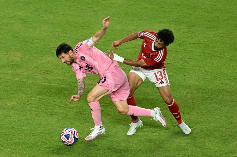 Inter Miami's Argentine forward #10 Lionel Messi and Al Ahly's Egyptian midfielder #13 Marwan Attia fight for the ball during the Club World Cup 2025 Group A football match between Egypt's Al-Ahly and US Inter Miami at the Hard Rock stadium in Miami on June 14, 2025. (Photo by ROBERTO SCHMIDT / AFP)