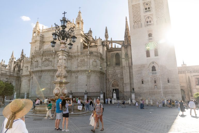 SEVILLE, SPAIN - MAY 15: Tourist walk next to the Cathedral of Saint Mary of the See, better known as Seville Cathedral, on May 15, 2022 in Seville, Spain. Rangers FC will face Eintracht Frankfurt in the UEFA Europa League final on May 18, 2022. (Photo by Maja Hitij/Getty Images)