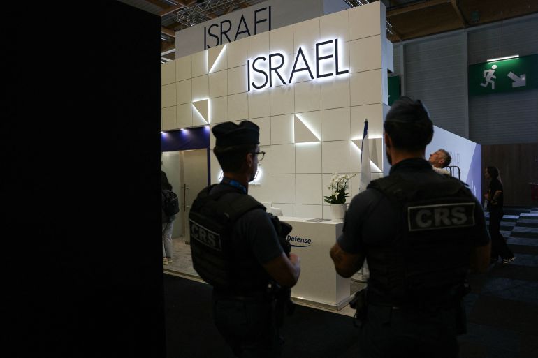 French Republican Security Corps (CRS - Compagnies Republicaines de Securite) police officers patrol in front of the closed Israeli Pavillon during the 55th edition of the International Paris Air Show at the Paris–Le Bourget Airport, in Le Bourget, suburb of Paris on June 16, 2025.