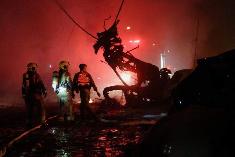 Emergency personnel operate after missiles were launched from Iran to Israel, in Haifa, Israel, June 15, 2025. REUTERS/Shir Torem