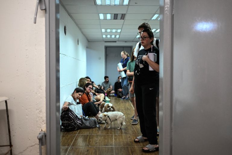Israelis take cover in a public shelter during a missile attack on Israel from Iran, at Haifa, Israel June 14, 2025. REUTERS/Rami Shlush ISRAEL OUT. NO COMMERCIAL OR EDITORIAL SALES IN ISRAEL