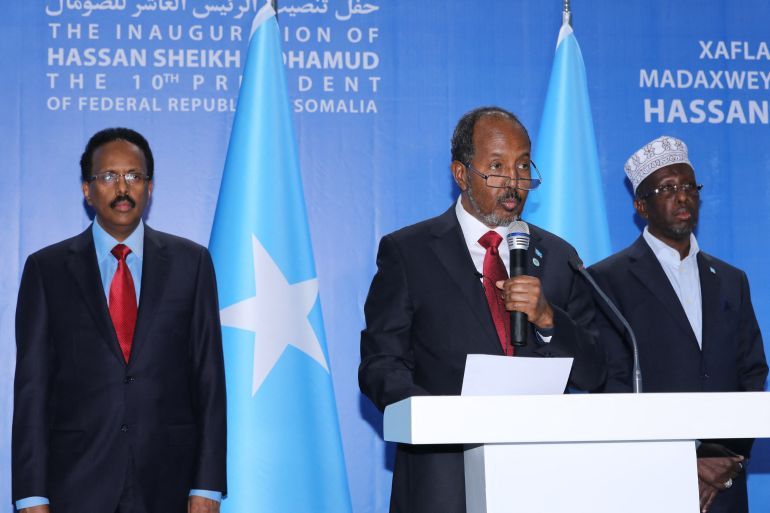 Somalia's new President Hassan Sheikh Mohamud (C) speaks with former President Mohamed Abdullahi Mohamed (L) and former President Sharif Sheikh Ahmed during his inauguration calemony as the 10th President with the presence of three heads of state, Kenya, Ethiopia, and Djibouti, in Mogadishu, Somalia, on June 9, 2022. (Photo by Hassan Ali ELMI / AFP)