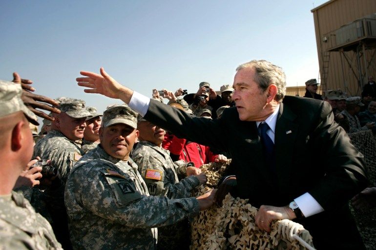Former US President George W Bush greets military personnel in Camp Arifjan, Kuwait [File: Brooks Kraft LLC/Corbis via Getty Images]