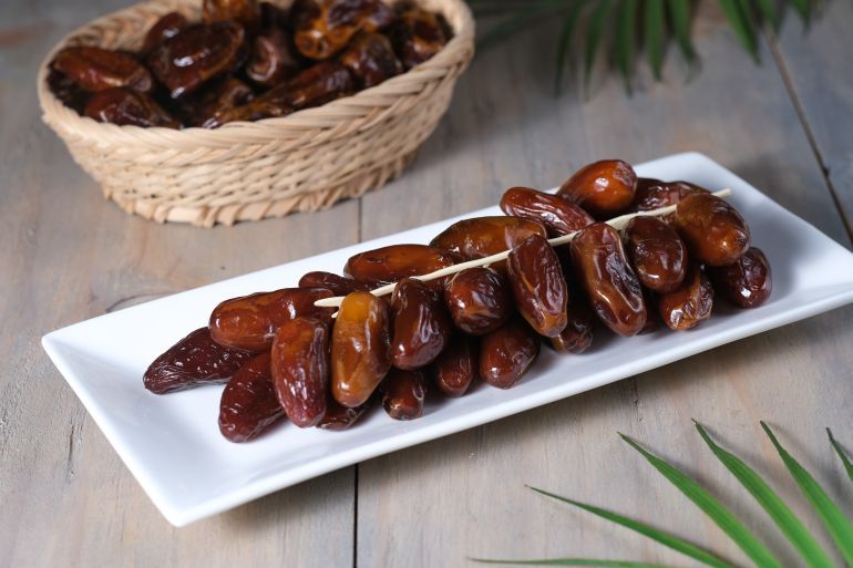 تقرير التمر المشترك - التمور في تونس Closeup delicious Kurma Tunisia or sweet dried date palm fruits on white plate. Much sought after during Ramadan to break the fast. ; Shutterstock ID 1948219048;